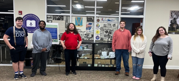 MGA history department representatives stand with their 483rd Bombardment Group archival collection in the Macon Campus Library.